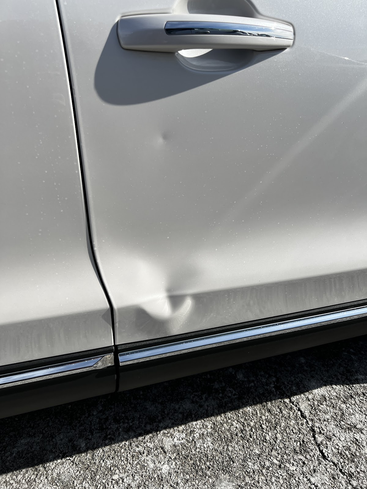 Dented body panel before repair