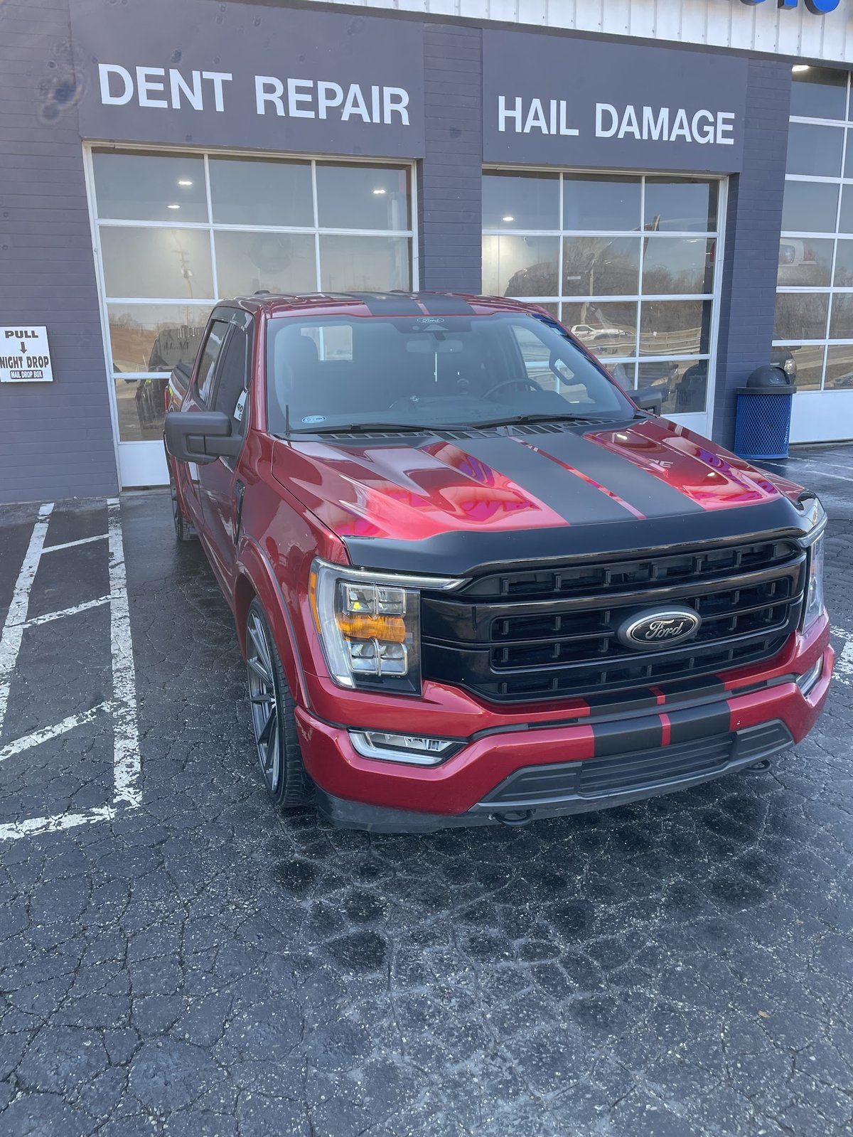 Custom Ford F-150 in front of the dent and hail repair bays