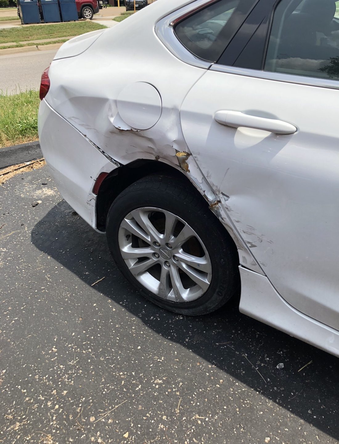 Collision damage to a vehicle's rear quarter panel, the kind of repair we handle through insurance claims