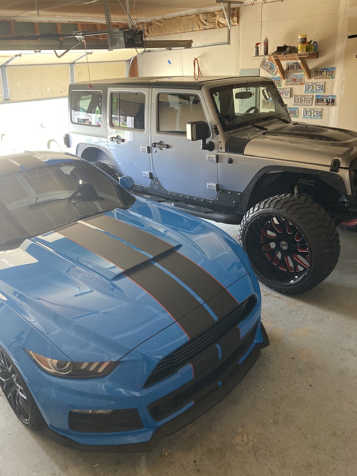Shelby Mustang GT350 and lifted Jeep Wrangler in the shop